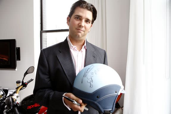 NEW YORK - AUGUST 29: Donald Trump Jr. signs a helmet at the Vespa display at the VMA Style Villa at the Bryant Park Hotel August 29, 2006 in New York City. (Photo by Amy Sussman/Getty Images For The Miami Group)