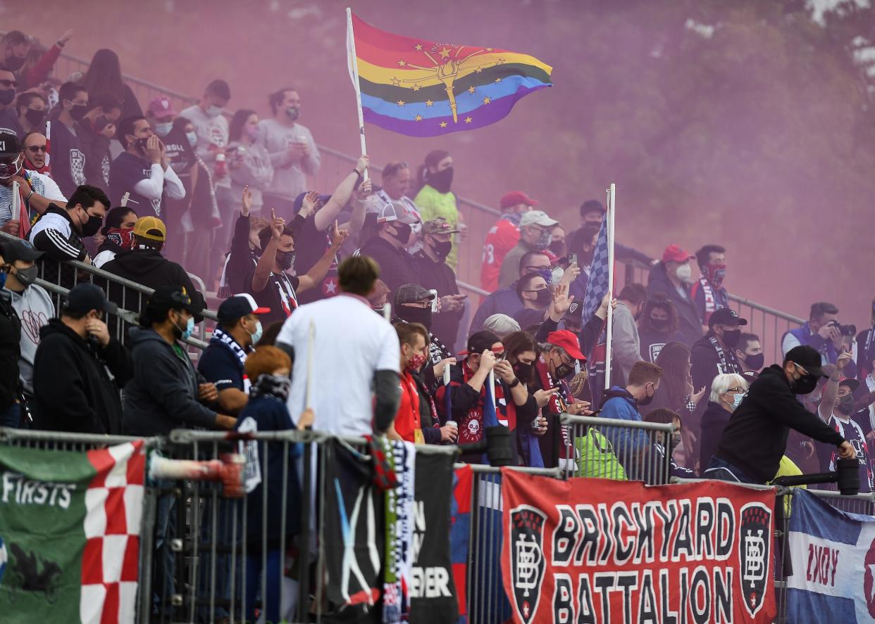 Brickyard Battalion fans celebrate kick-off with a smoke bomb in the first half of the home opener Saturday, May 8, 2021, at IUPUI's Carroll Stadium. After two years at Lucas Oil Stadium, the Eleven return to their original home for the season.