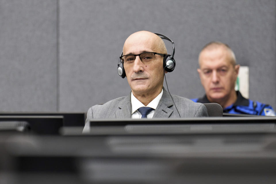 Salih Mustafa sits at a special Kosovo court in The Hague, Netherlands, Thursday, Dec. 14, 2023. Appeals judges at a special Kosovo court in the Netherlands were ruling Thursday in case of a former commander in the Kosovo Liberation Army who was convicted a year ago for arbitrarily detaining and torturing prisoners and murdering one of them during a late 1990s war for Kosovo’s independence. The commander, Salih Mustafa, was convicted a year ago and sentenced to 26 years’ imprisonment for the crimes committed at a KLA compound in Zllash, Kosovo, in April 1999. He was acquitted of one charge of mistreating detainees who were perceived as supporters of Serbia. (AP Photo/Phil Nijhuis, Pool)