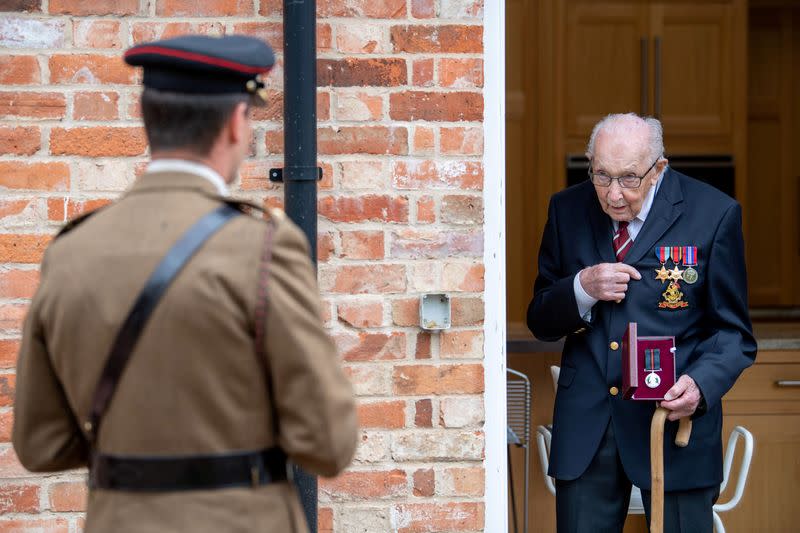 Former British Army Officer Captain Tom Moore, appointed the first Honorary Colonel of the Army Foundation College in Harrogate, holds his Yorkshire Regiment Medal next Lieutenant Colonel Thomas Miller in Bedford