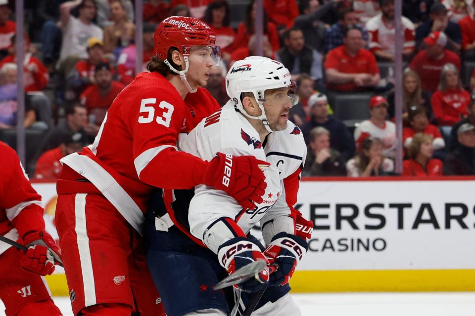 Detroit Red Wings defenseman Moritz Seider (53) and Washington Capitals left wing Alex Ovechkin (8) fight for position in the third period at Little Caesars Arena.