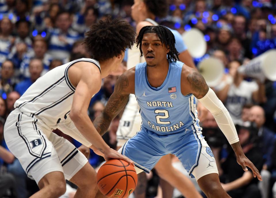 North Carolina Tar Heels guard Caleb Love (2) defends Duke Blue Devils guard Tyrese Proctor (5) during the first half at Cameron Indoor Stadium on Feb. 4, 2023 in Durham, North Carolina.