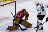 San Jose Sharks right wing Timo Meier, right, scores against Chicago Blackhawks goaltender Marc-Andre Fleury during the second period of an NHL hockey game in Chicago, Sunday, Nov. 28, 2021. (AP Photo/Nam Y. Huh)