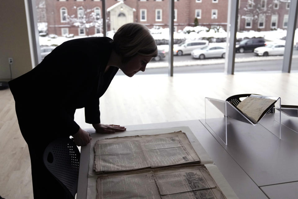 Elizabeth Pope, Curator of Books & Digital Collections, examines the writings of Louisa May Alcott, at the American Antiquarian Society, a national research library of pre-20th century American history and culture, Tuesday, Jan. 9, 2024, in Worcester, Mass. Max Chapnick, a postdoctoral teaching associate at Northeastern University, believes he has found about 20 stories and poems at the library written by Louisa May Alcott under her own name as well as pseudonyms, including E. H. Gould, for local newspapers in Massachusetts in the late 1850s and early 1860s. (AP Photo/Charles Krupa)