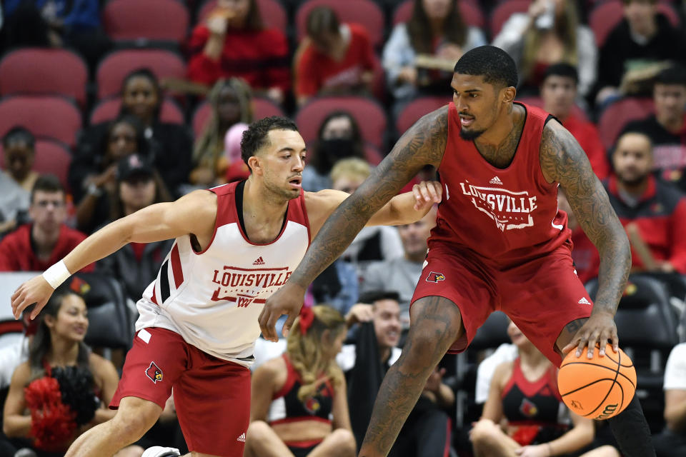 Louisville guard Jarrod West, left, attempts to defend forward Malik Williams during their NCAA college basketball scrimmage in Louisville, Ky., Saturday, Oct. 16, 2021. (AP Photo/Timothy D. Easley)