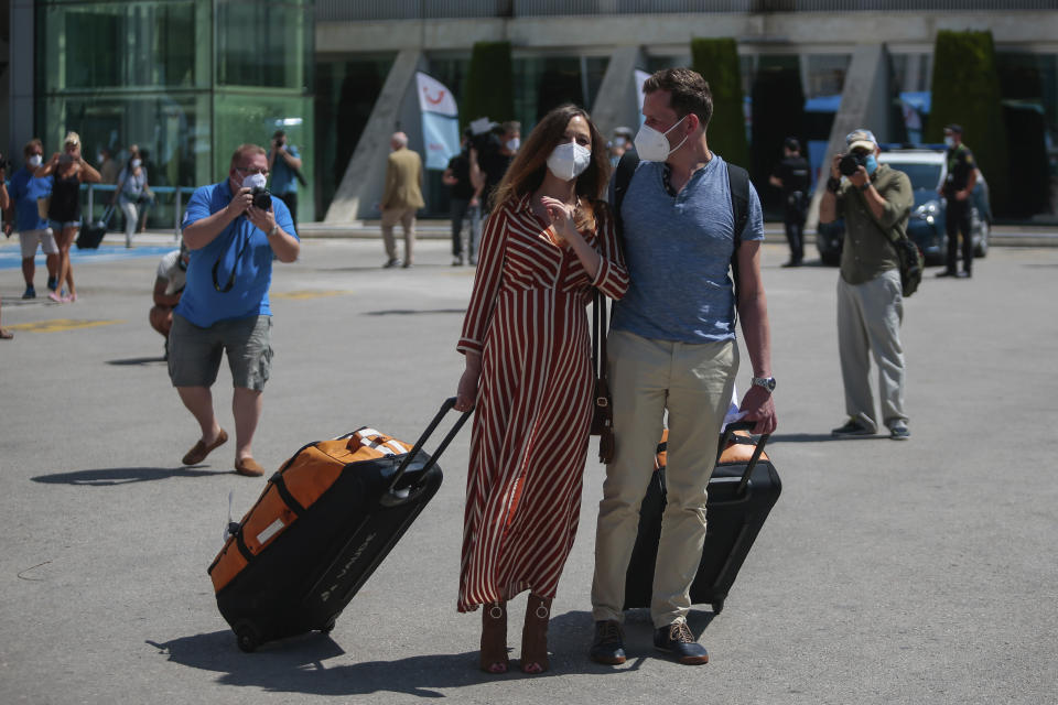 TUI X3 2312 Duesseldorf-Mallorca flight passengers arrive at Son Sant Joan airport in Palma de Mallorca, Spain, Monday, June 15, 2020. Borders opened up across Europe on Monday after three months of coronavirus closures that began chaotically in March. But many restrictions persist, it's unclear how keen Europeans will be to travel this summer and the continent is still closed to Americans, Asians and other international tourists. (AP Photo/Joan Mateu)