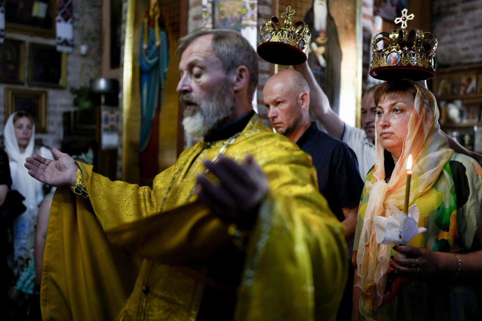 Pavlo Savryha and Oksana Savryha are married in Chernihiv, Ukraine, Sunday, June 19, 2022. The couple decided to marry after 18 years of being registered as a family, the day before Pavlo went to the frontline. A growing number of couples in Ukraine are speedily turning love into matrimony because of the war with Russia. Some are soldiers, marrying just before they head off to fight. Others are united in determination that living and loving to the full are more important than ever in the face of death and destruction. (AP Photo/Natacha Pisarenko)