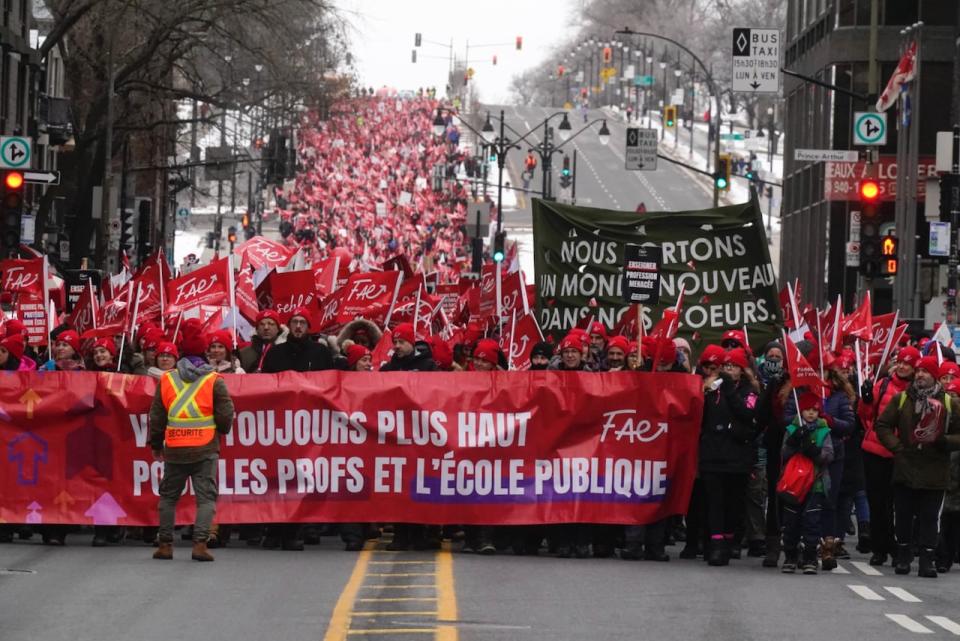 A day after making progress with the Quebec government at the negotiation table, teachers with the FAE take part in a march in Montreal's downtown core on Dec. 12, 2023.