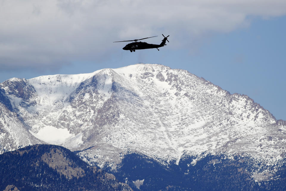 File-A Blackhawk helicopter circles Peterson Air Force Base before a visit by then Vice President Mike Pence, on April 18, 2020, in Colorado Springs, Colo. AI's predictive capabilities are helping the Air Force keep its fleet aloft, anticipating when key aircraft need maintenance. (AP Photo/David Zalubowski, File)