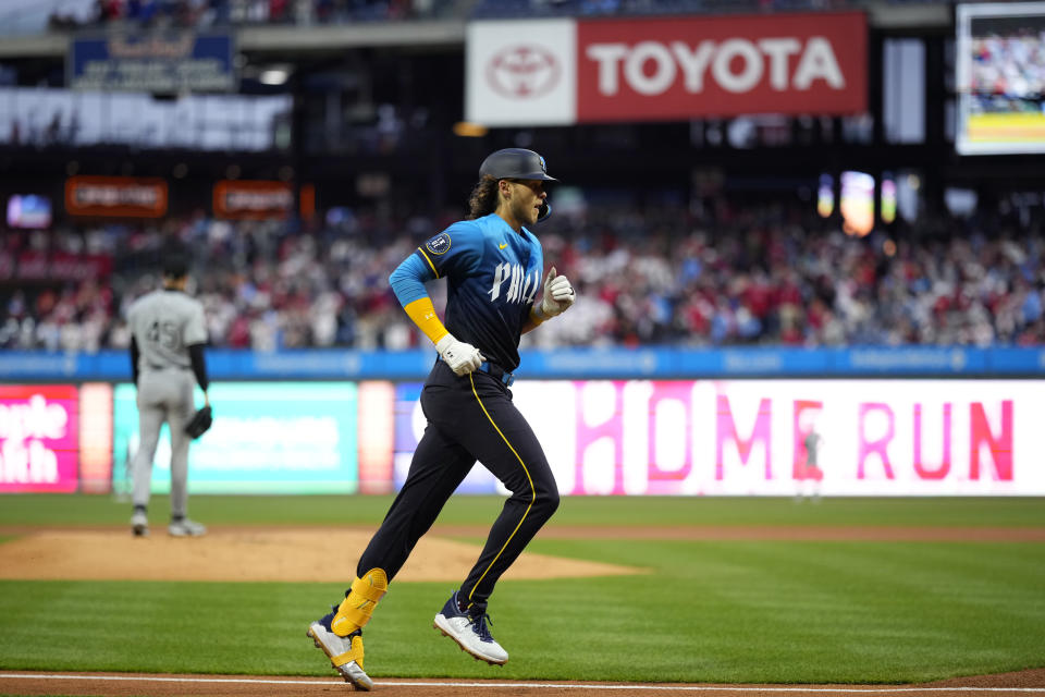 Philadelphia Phillies' Alec Bohm, right, rounds the bases after hitting a three-run home run against Chicago White Sox pitcher Garrett Crochet during the first inning of a baseball game, Friday, April 19, 2024, in Philadelphia. (AP Photo/Matt Slocum)