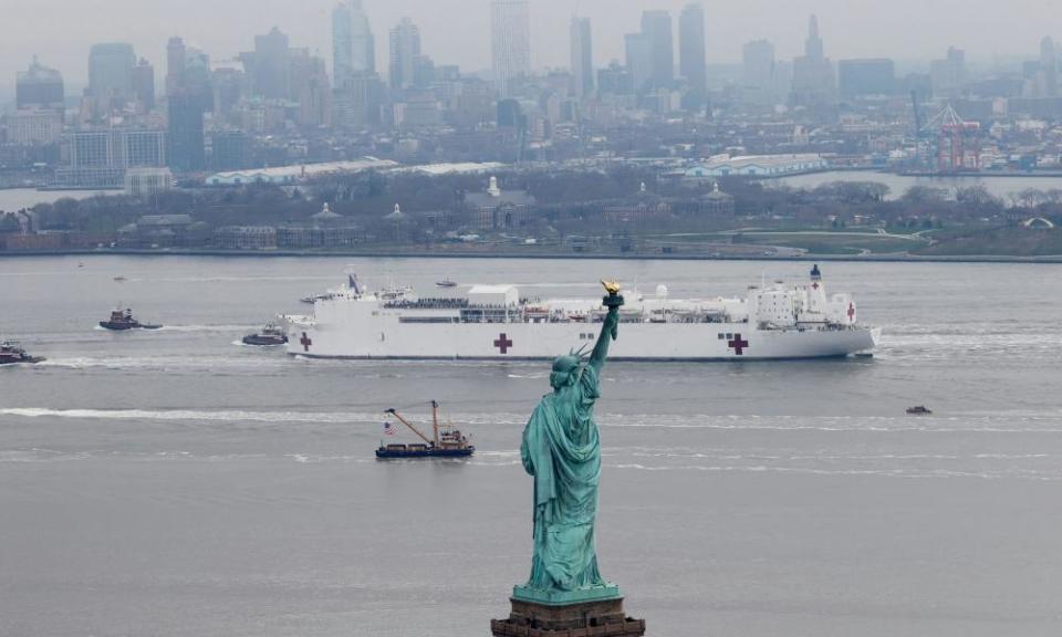 The USNS Comfort passes the Statue of Liberty as it enters New York Harbor on 30 March.