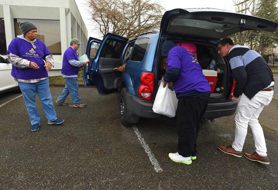 Danny Burkett, founder and CEO of Our Ark, and some of the nonprofit’s volunteers load up a van before going on a series of outreach visits on Sunday, March 26 to contact homeless youth.