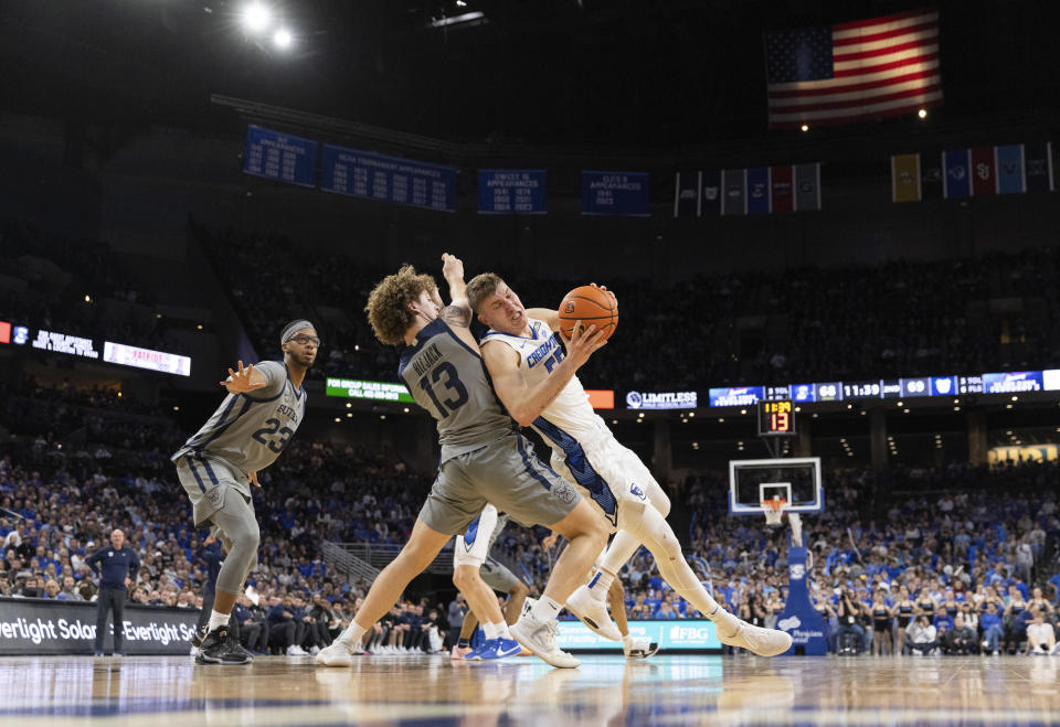 Creighton's Baylor Scheierman, right, slips while driving against Butler's Finley Bizjack, center, during the second half of an NCAA college basketball game Friday, Feb. 2, 2024, in Omaha, Neb. (AP Photo/Rebecca S. Gratz)
