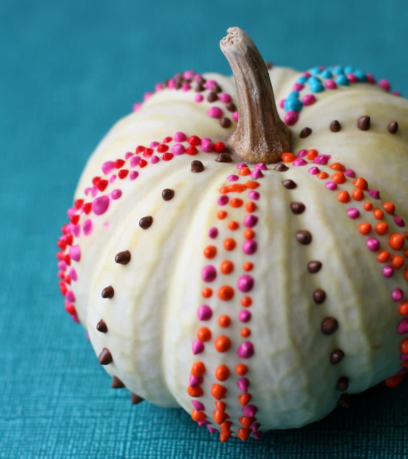 <p>Use this DIY pumpkin as a <a rel="nofollow noopener" href="https://www.womansday.com/home/decorating/g269/easy-fall-centerpiece-ideas-124043/" target="_blank" data-ylk="slk:colorful centerpiece;elm:context_link;itc:0;sec:content-canvas" class="link ">colorful centerpiece</a> for your Thanksgiving table. Choose the colors based on your table settings.</p><p><strong>Get the tutorial at <a rel="nofollow noopener" href="https://abeautifulmess.com/2009/11/diy-thanksgiving-pumpkin-project.html" target="_blank" data-ylk="slk:A Beautiful Mess.;elm:context_link;itc:0;sec:content-canvas" class="link ">A Beautiful Mess. </a></strong></p>