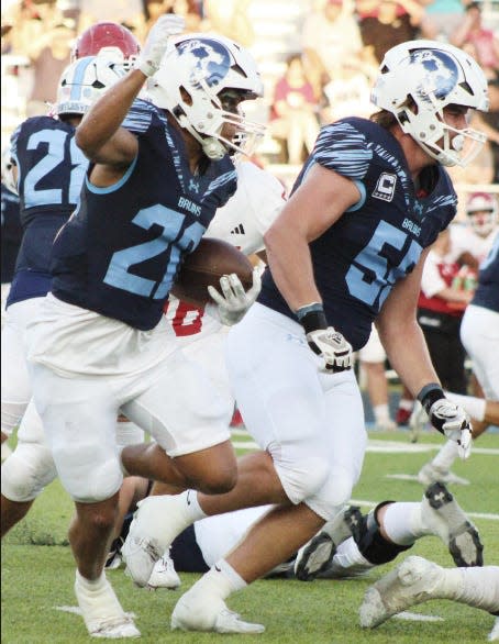 Bartlesville High School's Cooper Wood, left, clears he way for P.J. Wallace during football action against Claremore High School on Sept. 1, 2023.