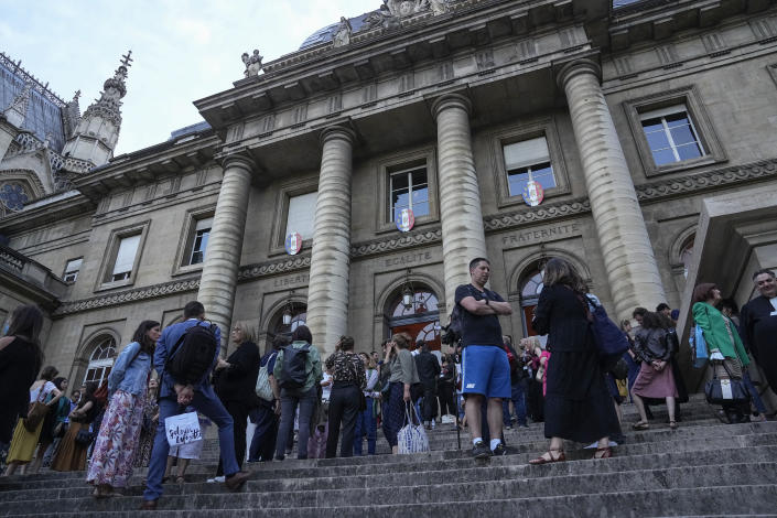 Lawyers and trial goers gather outside the court house after the verdict in Paris Wednesday, June 29, 2022. The lone survivor of a team of Islamic State extremists was convicted Wednesday of murder and other charges and sentenced to life in prison without parole in the 2015 bombings and shootings across Paris that killed 130 people in the deadliest peacetime attacks in French history. (AP Photo/Michel Euler)