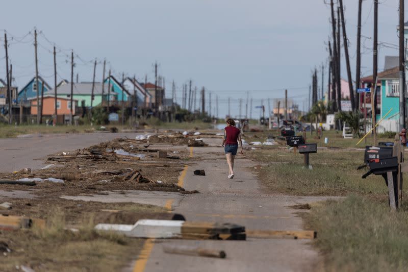 Resident walks past debris in the aftermath of Hurricane Beryl in Surfside Beach, Texas