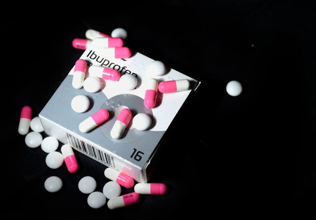 A number of pills sitting on a box and table