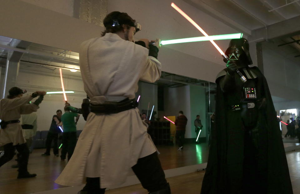 �Golden Gate Knights instructor Alain Bloch, left, and Gary Ripper, dressed as Darth Vader, demonstrate light saber moves during class in San Francisco, Sunday, Feb. 10, 2013. A group of San Francisco Star Wars fans who want to travel to a galaxy not that far away have created a combat choreography class for Jedis-in-training with their weapon of choice: the light saber. (AP Photo/Jeff Chiu)