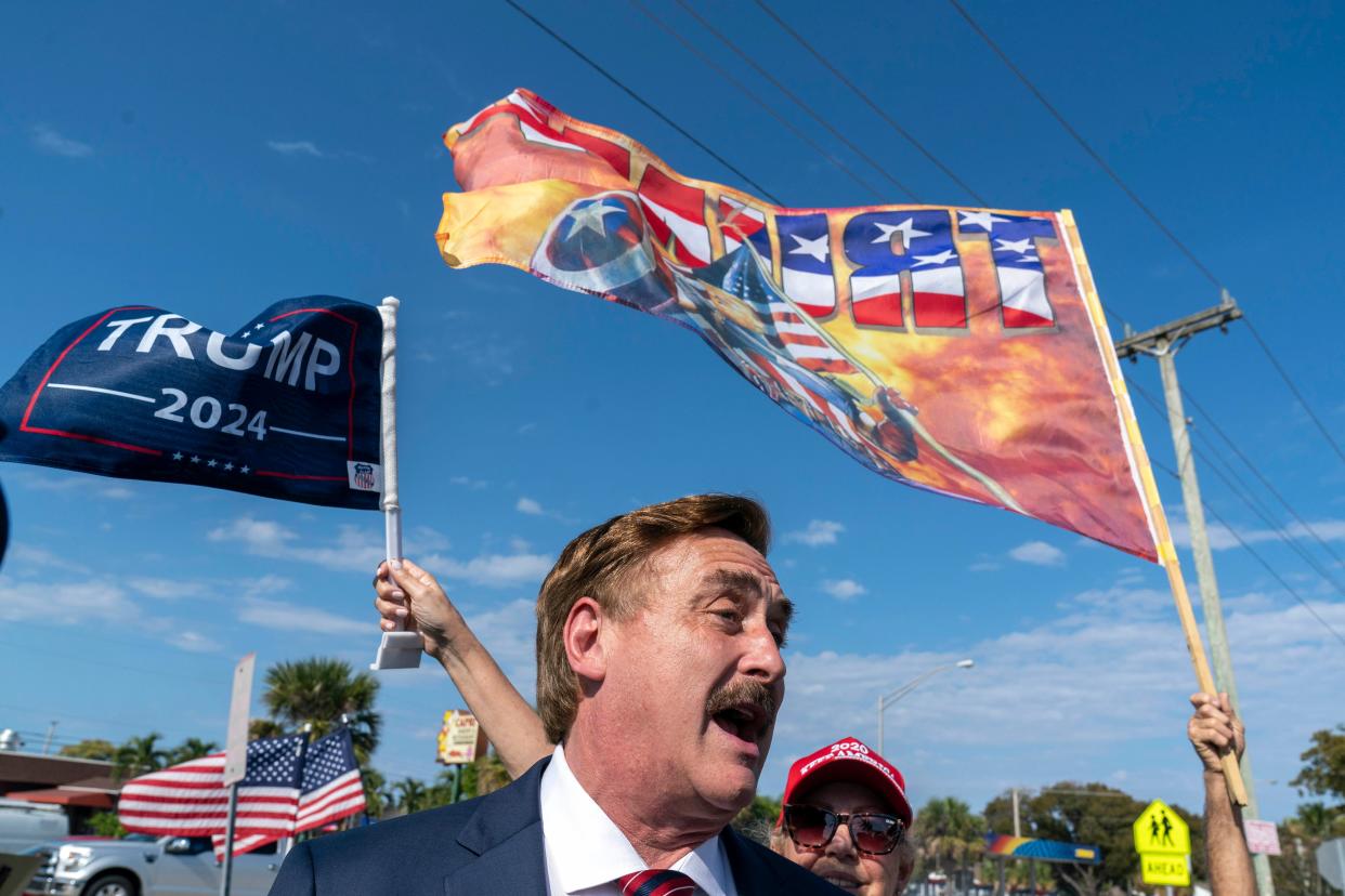 Mike Lindell, the My Pillow Inc chief executive greets Trump supporters as they wait along the motorcade route for former President Donald Trump to return home to Mar-a Lago following his arraignment in New York on April 4, 2023.