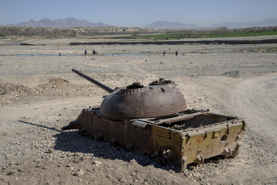 A Soviet tank sits abandoned in a remote region of Afghanistan, on Wednesday, Feb. 22, 2023. In a nearby village, a baby was orphaned during a U.S. raid in 2019. A Marine who adopted her claims her parents were foreign fighters. But villagers say they were innocent farmers caught in the fray. (AP Photo/Ebrahim Noroozi)