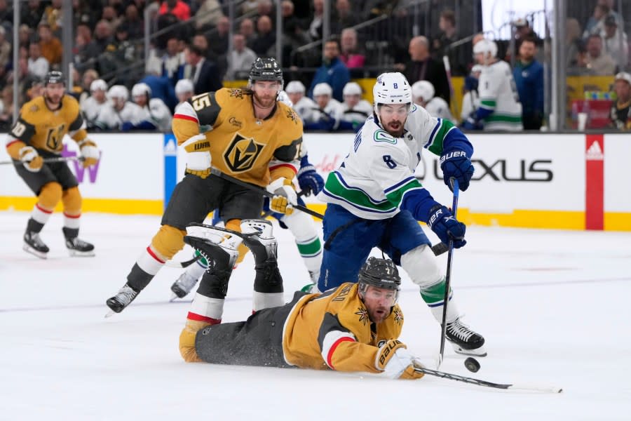 Vegas Golden Knights defenseman <a class="link " href="https://sports.yahoo.com/nhl/players/4474/" data-i13n="sec:content-canvas;subsec:anchor_text;elm:context_link" data-ylk="slk:Alex Pietrangelo;sec:content-canvas;subsec:anchor_text;elm:context_link;itc:0">Alex Pietrangelo</a> (7) reaches for the puck against Vancouver Canucks right wing <a class="link " href="https://sports.yahoo.com/nhl/players/6865/" data-i13n="sec:content-canvas;subsec:anchor_text;elm:context_link" data-ylk="slk:Conor Garland;sec:content-canvas;subsec:anchor_text;elm:context_link;itc:0">Conor Garland</a> (8) during the third period of an NHL hockey game Thursday, March 7, 2024, in Las Vegas. (AP Photo/Lucas Peltier)