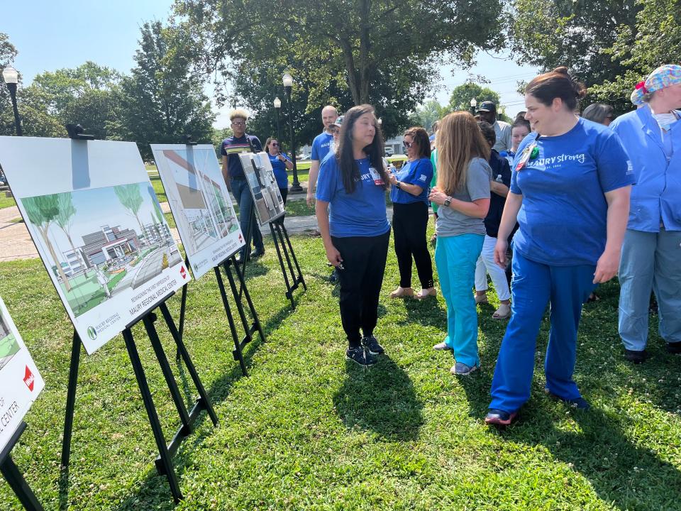 (Right) Melinda James, a nursing unit coordinator at Maury Regional Medical Center, explores the viewing station at the Maury Regional Medical Center expansion unveiling on the hospital lawn on Friday June 30, 2023.