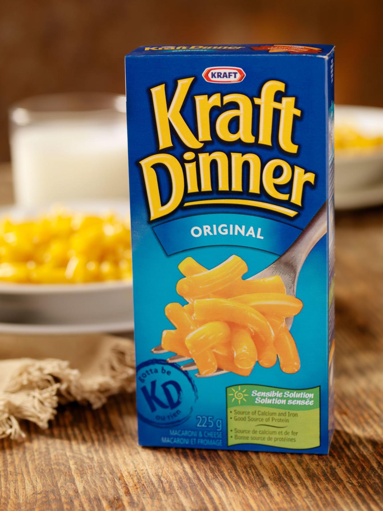 A 225g cardboard package of CANADIAN Kraft Macaroni and Cheese Dinner shot in Studio on a Table setting