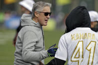 NFC head coach Pete Carroll, of the Seattle Seahawks, talks to running back Alvin Kamara, of the New Orleans Saints, during a practice for the NFL Pro Bowl football game Wednesday, Jan. 22, 2020, in Kissimmee, Fla. (AP Photo/Chris O'Meara)