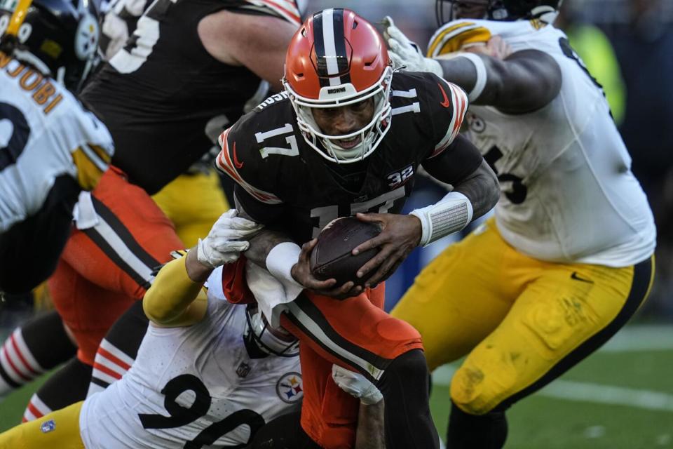 Pittsburgh Steelers linebacker T.J. Watt (90) pulls down Cleveland Browns quarterback Dorian Thompson-Robinson (17).