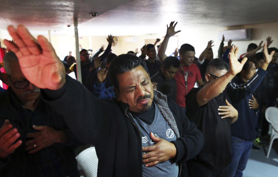 Evangelicals hold up their hands in prayer for their neighbor Christina Langford Johnson a victim of a cartel ambush that killed nine American women and children earlier this week, at the “Fuente de Vida” church in Colonia LeBaron, Mexico, Saturday, Nov. 9, 2019. In the attack Monday, Langford Johnson jumped out of her vehicle and waved her hands to show she was no threat to the attackers and was shot twice in the heart, community members say. Her daughter Faith Marie Johnson, 7 months old, was found unharmed in her car seat. (AP Photo/Marco Ugarte)