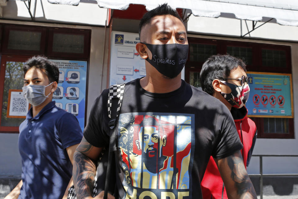 Australian national William Cabantog, center, leaves Kerobokan prison in Bali, Indonesia Saturday, July 25, 2020. Cabantog is released from the prison where he has served to twelve months. Cabantog and another man were arrested last July at the Lost City Club on Indonesia's resort island of Bali with 1.12 grams of cocaine. (AP Photo/Firdia Lisnawati)