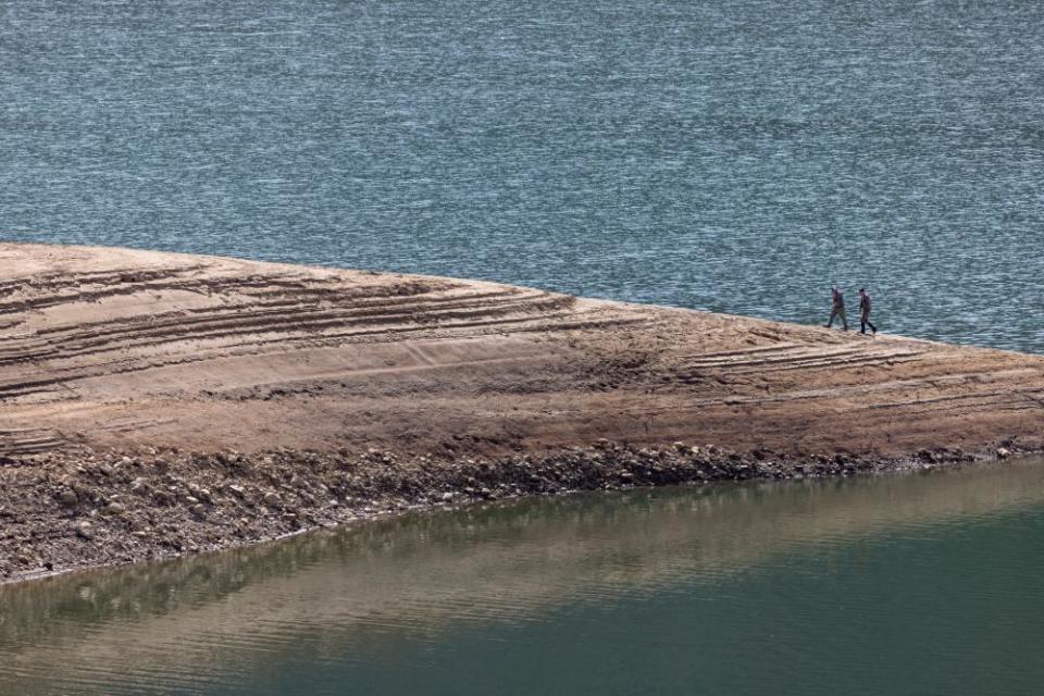 Hunters walk on a rocky berm at the nearly empty Palisades reservoir on 23 September near Irwin, Idaho.