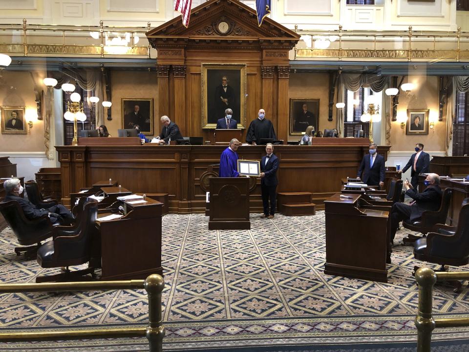 South Carolina Senate President Harvey Peeler, left, presents a resolution to state Sen. Greg Gregory, right, before Gregory gives his farewell speech on Tuesday, Sept 22, 2020, at the Statehouse in Columbia, South Carolina. Gregory, a Republican from Lancaster, has spent 24 years in the South Carolina Senate. (AP Photo/Jeffrey Collins)