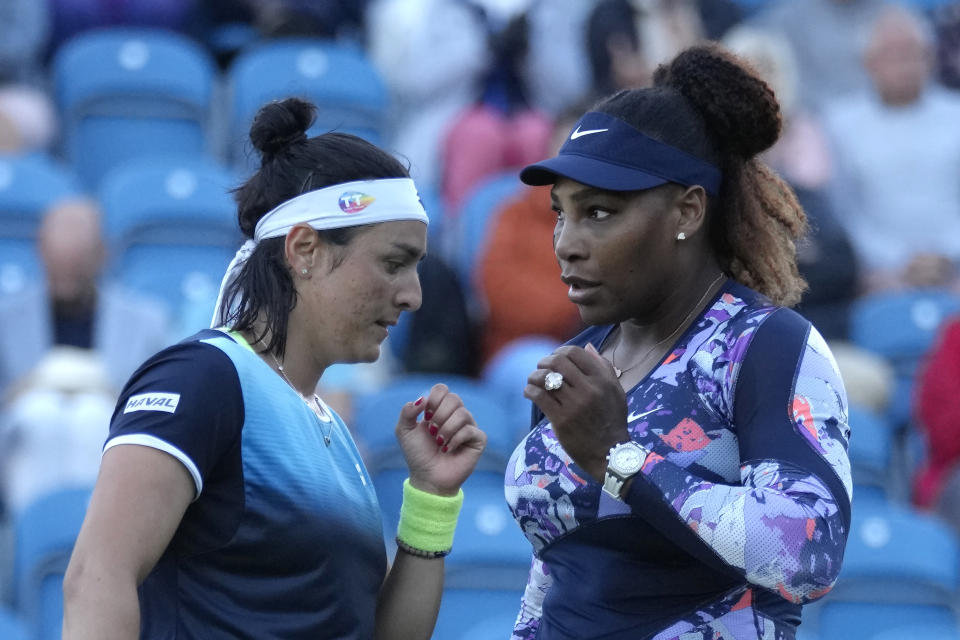 Serena Williams of the United States and Ons Jabeur of Tunisia speak before playing a point against Shuko Aoyama of Japan and Hao-Ching of Taiwan during their quarterfinal doubles tennis match at the Eastbourne International tennis tournament in Eastbourne, England, Wednesday, June 22, 2022. (AP Photo/Kirsty Wigglesworth)