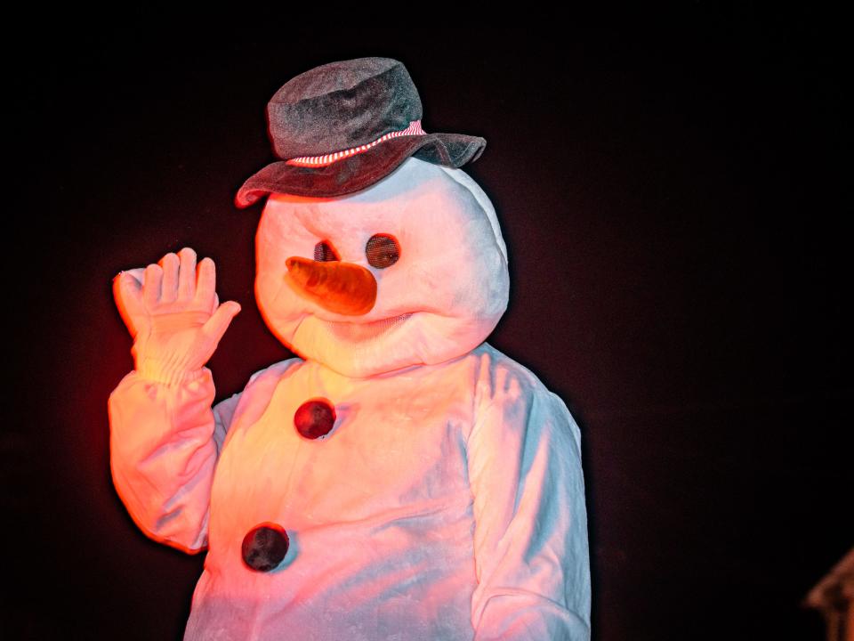 Bloxom Fire Department's  snowman waves to the crowd at Chincoteague Christmas parade.