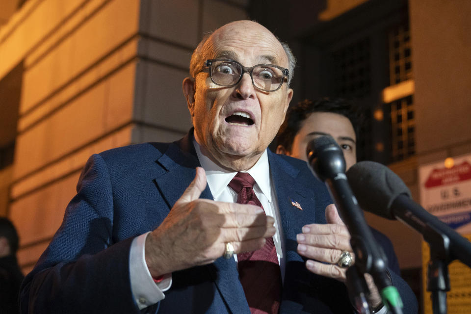 Former New York Mayor Rudy Giuliani talks to reporters as he leaves the federal courthouse in Washington, Monday, Dec. 11, 2023. The trial will determine how much Giuliani will have to pay two Georgia election workers who he falsely accused of fraud while pushing President Donald Trump's baseless claims after he lost the 2020 election. (AP Photo/Jose Luis Magana)