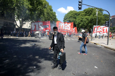 A protester looks on during clashes outside the Congress in Buenos Aires, Argentina December 14, 2017. REUTERS/Agustin Marcarian