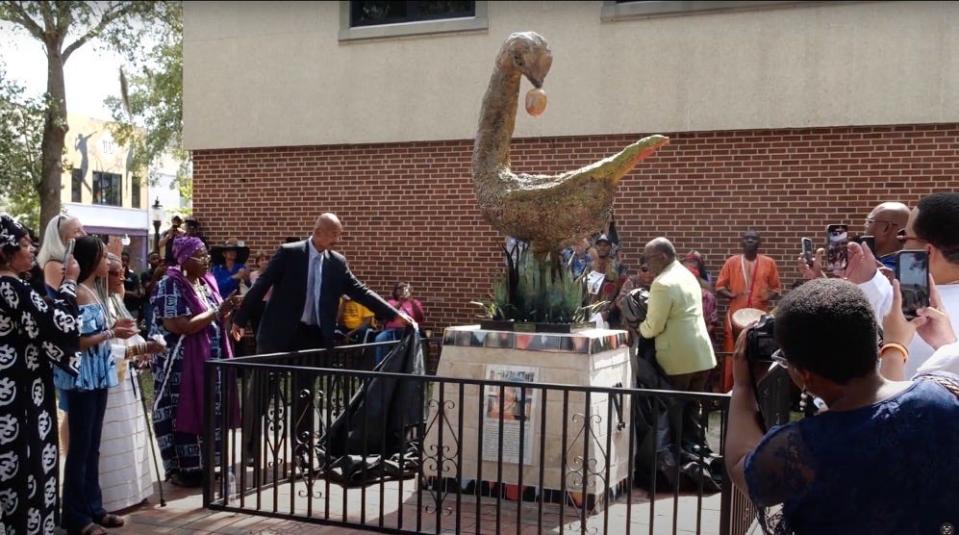 County Commissioner Chuck Chestnut IV unveils the Sankofa bird statue to honor the late Patricia Hilliard-Nunn in front of the Alachua County Administration Building. Hilliard-Nunn played a pivotal role in researching and launching the county’s Truth and Reconciliation initiative.