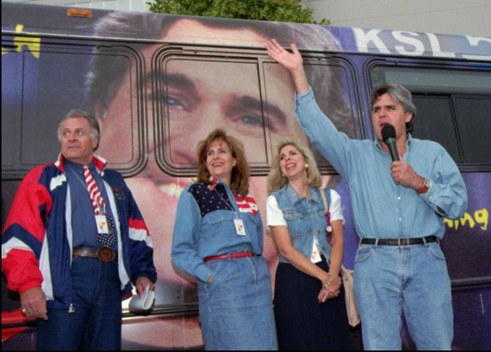 Jay Leno laughs with local TV personalities Dick Nourse, Ruth Todd and Carole Mikita in front of a UTA bus sporting Leno’s mug. | Kristan Jacobsen, Associated Press