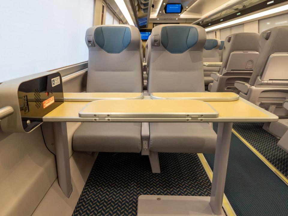 A two-person seating and table configuration inside new Amtrak Acela.