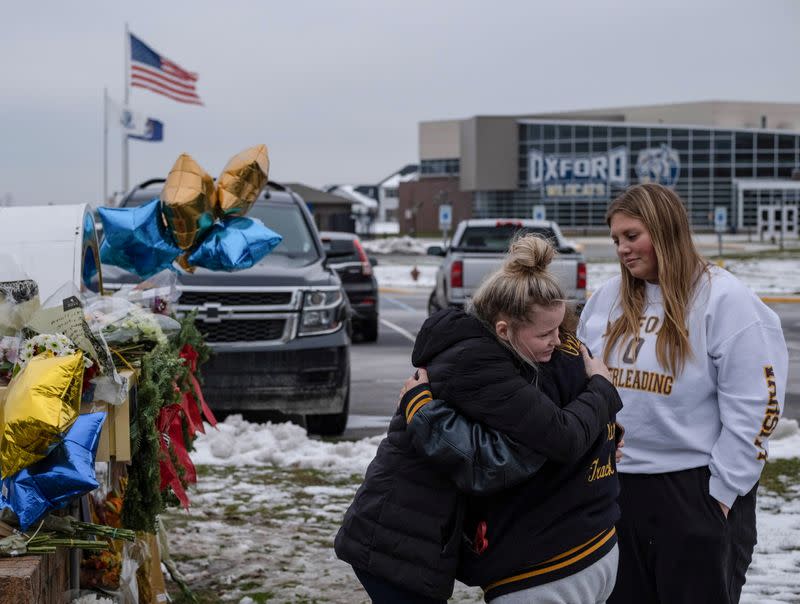 People pay their respects at a memorial at Oxford High School, a day after a shooting that left four dead and eight injured, in Oxford