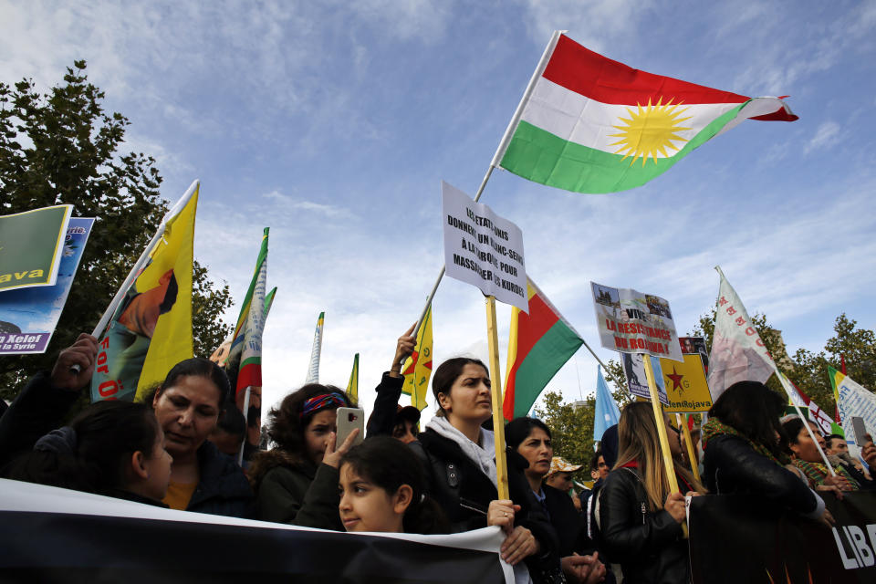 Protesters take part of a demonstration against Turkey's offensive in northern Syria, on Republique plaza in eastern Paris, Saturday, Oct. 19, 2019. Demonstrators warned that the offensive could allow Islamic State extremists to resurge. Kurdish forces being targeted by Turkey this week were crucial to the international campaign against IS extremists, who orchestrated several deadly attacks against France. (AP Photo/Thibault Camus)