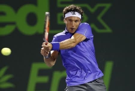 Juan Monaco hits a backhand against Guillermo Garcia-Lopez (not pictured) on day seven of the Miami Open at Crandon Park Tennis Center. Mandatory Credit: Geoff Burke-USA TODAY Sports