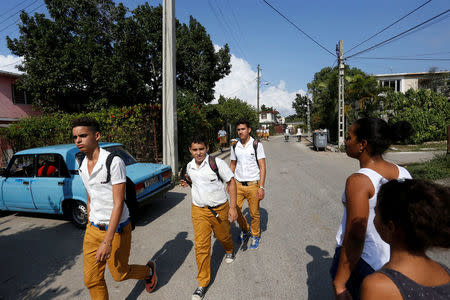 People walk on a street in Jaimanitas where Cuba's former President Fidel Castro lived in Havana, Cuba, December 2, 2016. Picture taken December 2, 2016. REUTERS/Stringer