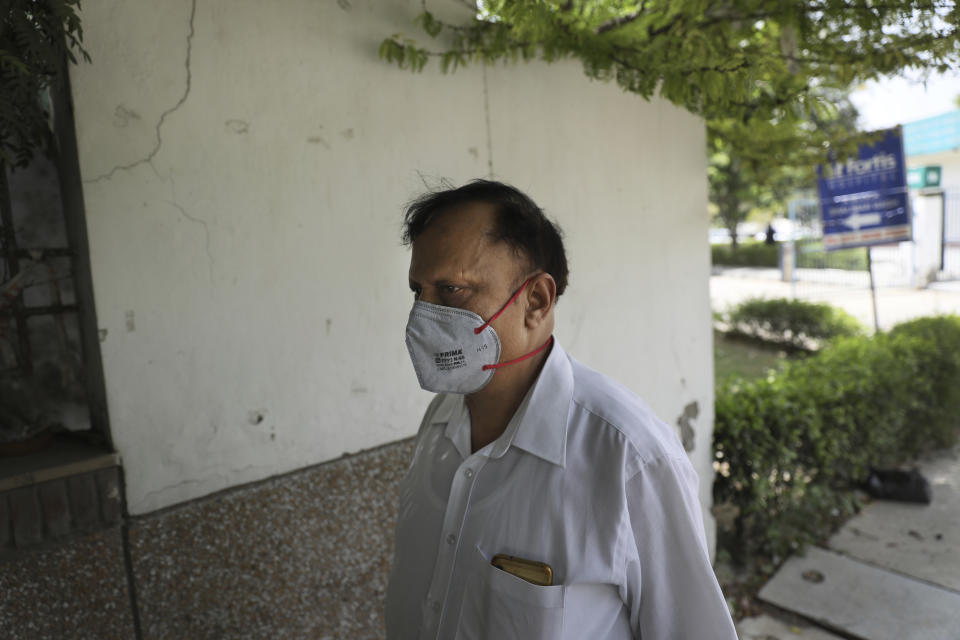 Anil Sharma leaves a hospital after visiting his son, Saurav, who is being treated for COVID-19 at a private hospital in New Delhi, India, Thursday, July 1, 2021. Life is tentatively returning to normal in India as coronavirus cases fall. But millions are embroiled in a nightmare of huge piles of medical bills. Most Indians don't have health insurance and costs for COVID-19 treatment have them drowning in debt. (AP Photo/Manish Swarup)