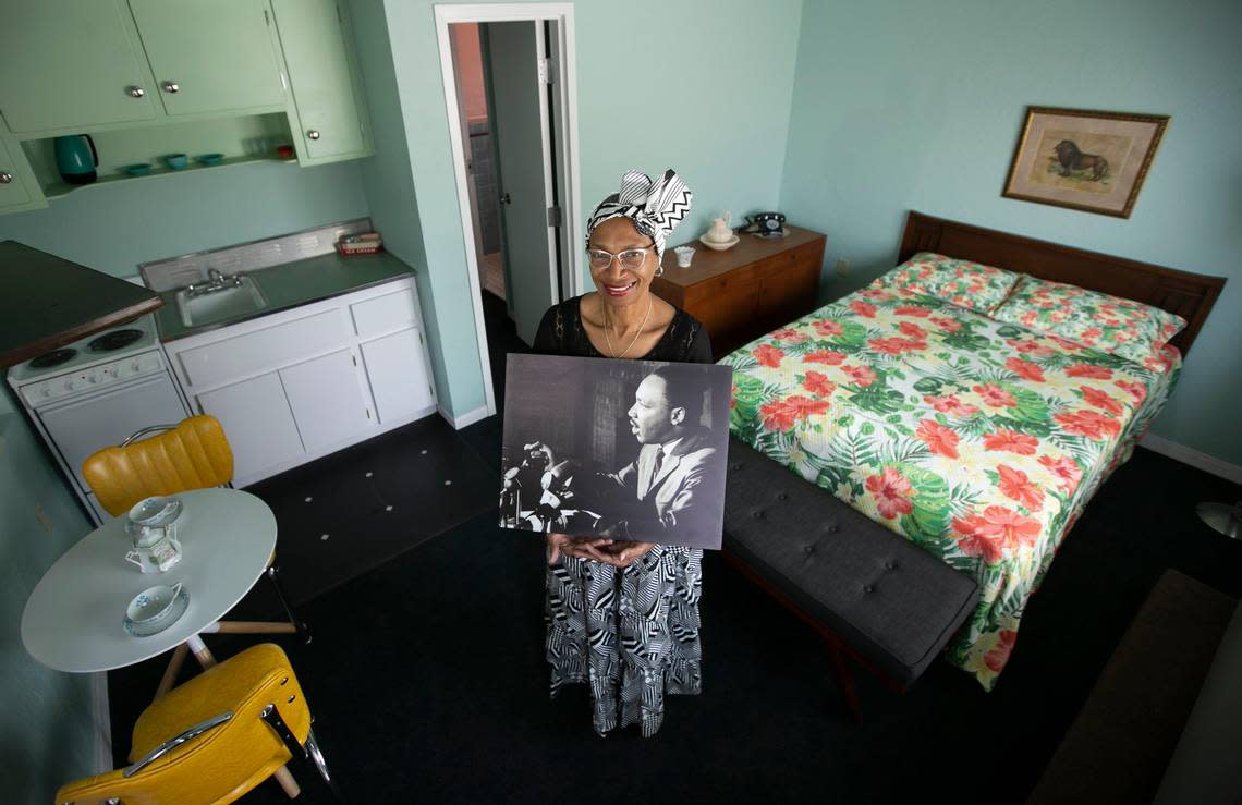 The former president/CEO of the Historic Hampton House, Charlayne W. Thompkins, holds a photograph of Martin Luther King Jr. while standing inside one of his favorite rooms at the Hampton House in Miami. It is said that King gave one of the early versions of his pivotal ‘I Have a Dream’ speech at the Hampton House. This is a file photo from 2020.