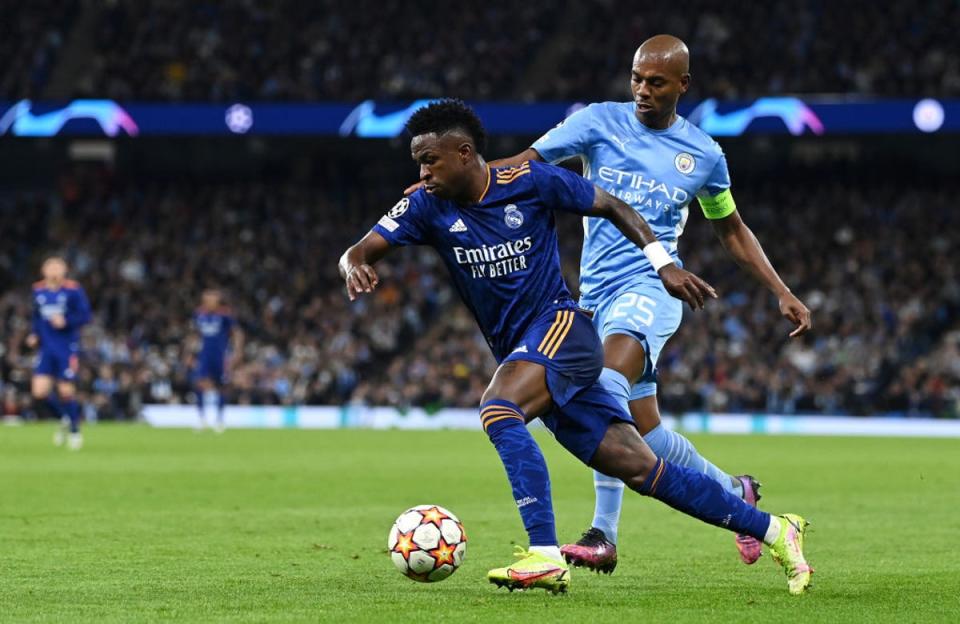 Real Madrid’s Vinicius Junior is shadowed by Manchester City’s Fernandinho in last year’s semi-final first leg at the Etihad (Getty)