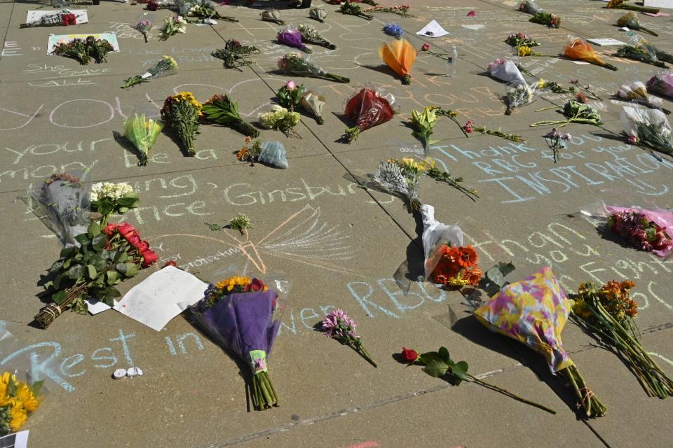 Flowers are placed in front of the US Supreme Court on Sept. 19, 2020 to honor the life of Associate Justice Ruth Bader Ginsburg. 