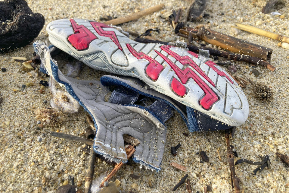 Personal belongings among the wreckage of a capsized boat washed ashore at a beach near Cutro, southern Italy, Monday, Feb. 27, 2023. Rescue crews searched by sea and air Monday for the dozens of people believed still missing from a shipwreck off Italy’s southern coast that drove home once again the desperate and dangerous crossings of migrants seeking to reach Europe. (AP Photo/Paolo Santalucia)